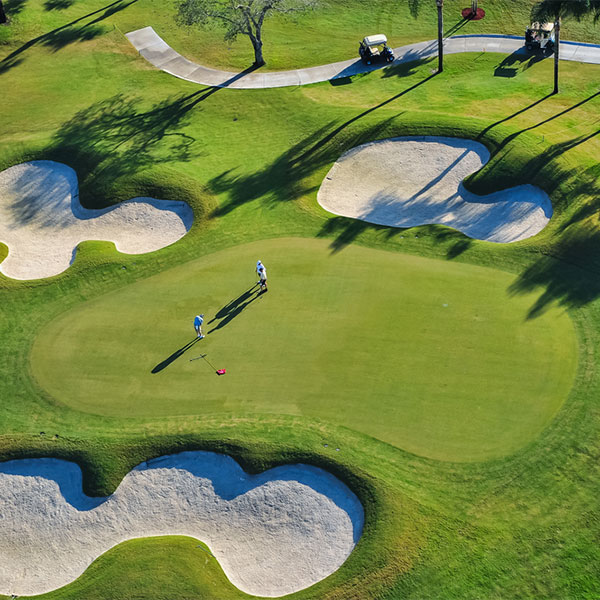 arial view of golf course with two people playing